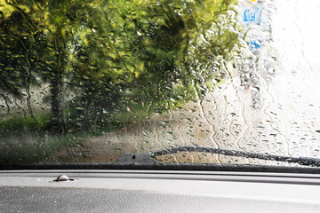 rain and tornado while driving on the road on the windshield. natural disaster