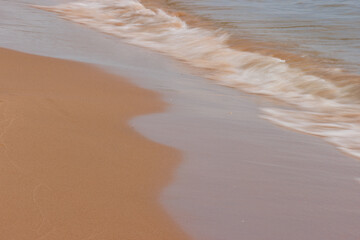 Lake Michigan washes casually up the sloped beach edge at Harrington Beach State Park, Belgium,...
