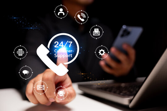 A person interacts with a digital interface displaying 24/7 customer support icons while using a smartphone and laptop.