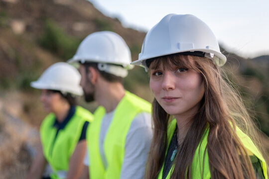 Young female engineer leading team in sustainable construction project