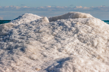 The top of an ice volcano on the shore of Lake Michigan at Harrington Beach State Park, Belgium, Wisconsin, quiet with the calm water in early January