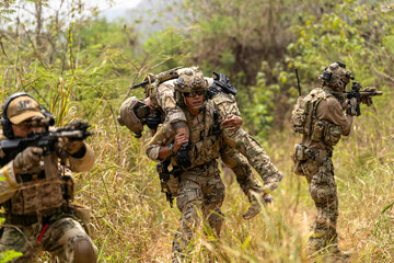 Soldier Carrying Injured Comrade During Tactical Combat Mission – Military Rescue Operation in...