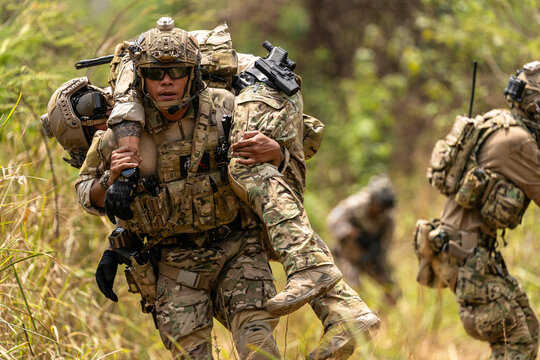 Soldier Carrying Injured Comrade During Tactical Combat Mission – Military Rescue Operation in Jungle, Armed Forces in Full Gear Providing Assistance Under Fire, Real Battlefield Scene