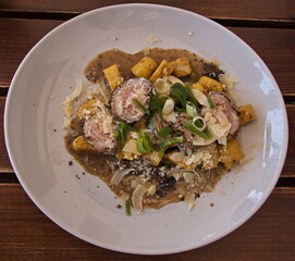 Pork meat with potato gnocchis and mushroom sauce in a restaurant in Czech republic, Europe

