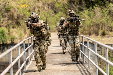 Special Forces Unit Conducting Tactical Patrol on Bridge – Armed Soldiers with Rifles and Full...