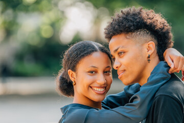 young Latin couple embracing on the street