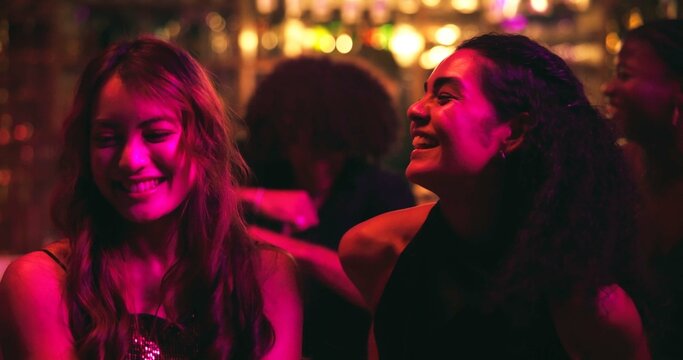 Girl, dancing and happy with friends at nightclub with celebration, party and social event at bar. People, women and smile with rhythm, culture and excited with music for new years eve at restaurant