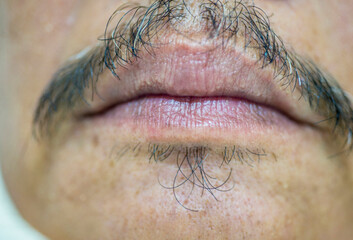 Close up of person with male lips and mustache