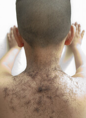 The back of the boy Just finished cutting There is also a piece of cut hair to the back of the child.
