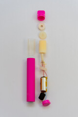 Electronic cigarette in disassembled form - a view of the internal mechanisms and materials.