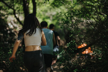 People navigate a dense forest trail, enjoying outdoor adventure and nature. The vibrant greenery...