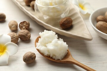 Natural shea butter on white wooden table, closeup
