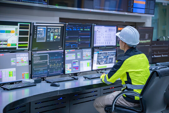 Engineer working at control room, Manager control system, Technician man monitoring program from a lot of monitor.Specialist observes analytics dashboard,operator inspects digital interface