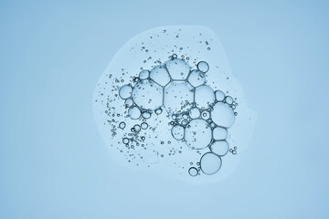 Delicious serum texture with bubbles on a blue background.