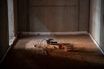 Angle grinder resting on freshly cut bricks at a construction site, showcasing power tool use and...