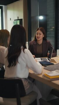 Corporate employee in Asia supervising mentor session for trainee in office with teamwork and career focus