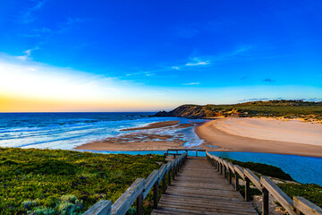 Obraz premium View of picturesque Amoreira beach on Algarve coast in Portugal on sunrise