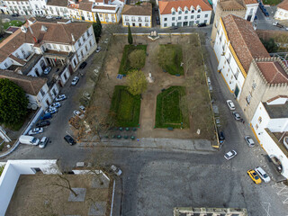 Aerial view of Jardim Diana in &Eacute;vora, Portugal, with Roman Temple ruins and historic architecture surrounded by green trees and cobbled streets.