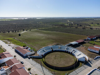 Aerial view of the bullring in Aldeia da Luz, Mour&atilde;o, Alentejo, Portugal. Captured by drone, showing traditional architecture and rural landscape.