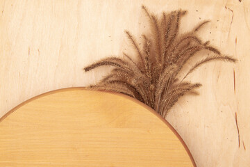 Fluffy decorative spikelets on wooden background with copy space. Greeting card with Rustic charm and delicate grass.