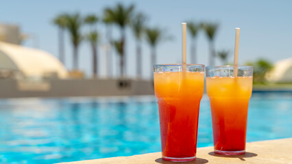 Two fresh cocktails by the pool on the beach by the sea