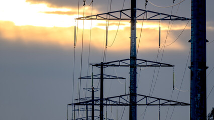 High-voltage power lines in the background of sunset or dawn