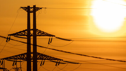 High-voltage power lines in the background of sunset or dawn