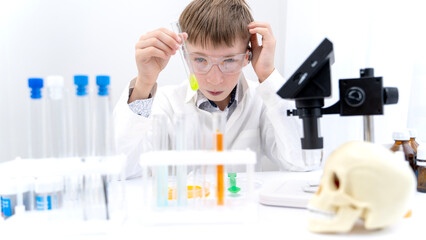 A boy student conducts chemical experiments in a chemical laboratory