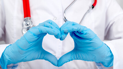 Doctor with stetascope holding heart in hands. The concept of health and medicine