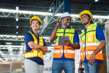 Diverse workfoce team black men,woman factory worker wear safety helmet, safety vest use tablet for industrial warehouse job.Teamwork efficient success modern logistic manufacture operation management