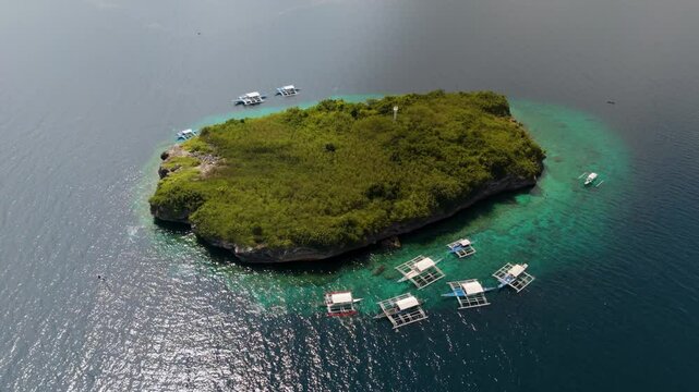 Full Aerial Island View of sunny paradise Pescador Island Surrounded by Bangkas boats and Turquoise vibrant Waters &ndash; Moalboal, Cebu, Philippines