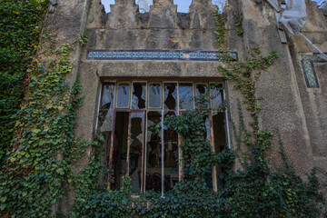Broken window of abandoned building at the Garden of Tropical Agronomy in Paris, France, Europe. 