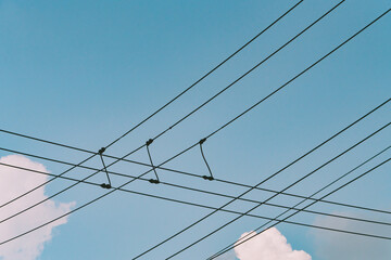 Intersecting Wires Under Blue Sky
