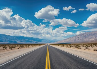 A vast, empty highway stretches into a mountainous horizon beneath a vibrant, cloud-filled sky