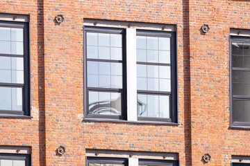 Industrial building brick facade with modern black framed windows.