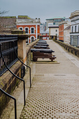 Historic cannons are positioned atop the ancient Londonderry City Walls, offering a glimpse into...