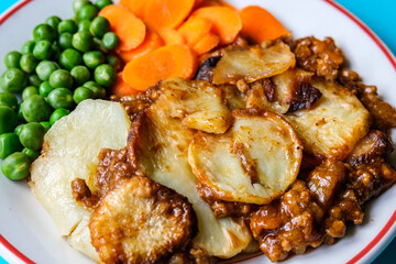 Traditional British Favourite Beef Hotpot With Carrots and Peas
