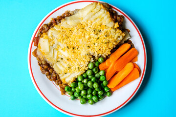 Vegetarian or Veggie Cottage Pie With Carrots And Peas Topped With Mash Potato