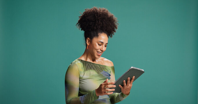 Fototapeta Tablet, smile and woman in studio for reading fashion blog, email or social media. Digital technology, online chat and happy African model download app, trendy article or mockup space on background