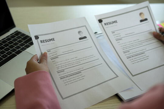 A young asian female Head of HR is reading resume and making a call for the recruitment interview  process with the candidate who has been selected to work in the company, employment and HR concept.