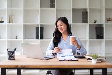 Female employee holding account documents, checking information