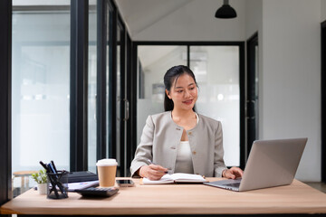 Businesswoman working with laptop in office, smiling face