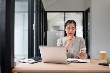 Businesswoman working with laptop in office, smiling face