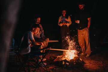 A group of friends gathered around a campfire at night, sharing stories and drinks under the stars, creating a cozy and enjoyable outdoor experience.
