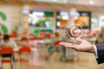 Hand holds digital checkmark in busy setting.