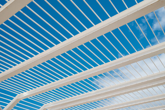 White steel beams and blue sky creating modern architectural design - Powered by Adobe