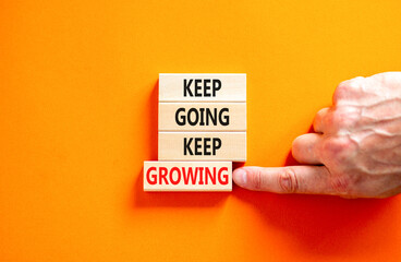 Keep going and growing symbol. Concept words phrase Keep going keep growing on beautiful wooden...