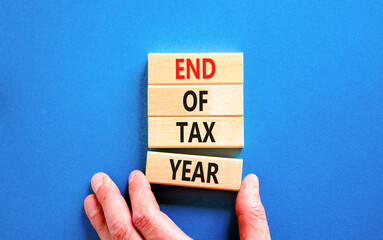 End of tax year symbol. Concept words phrase End of tax year on beautiful wooden blocks. Beautiful...