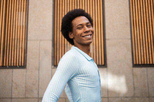 Person smiling against urban backdrop