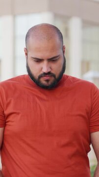 Vertical Video of Bald indian Man feeling Guilty